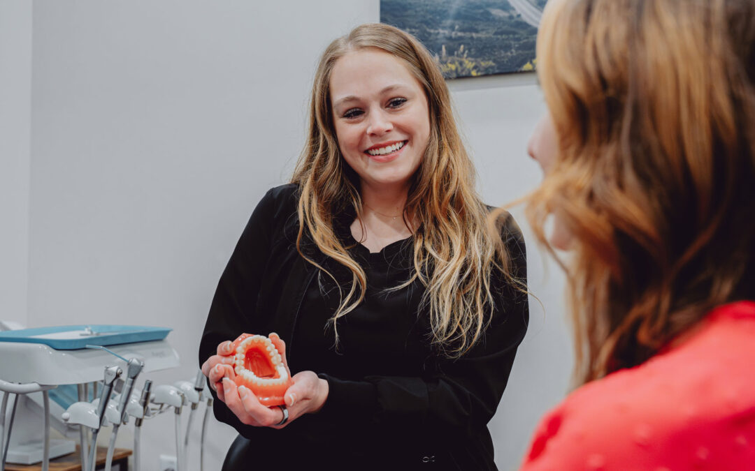 Dentist explaining dental model at Hometown Smiles Dentistry in League City, TX