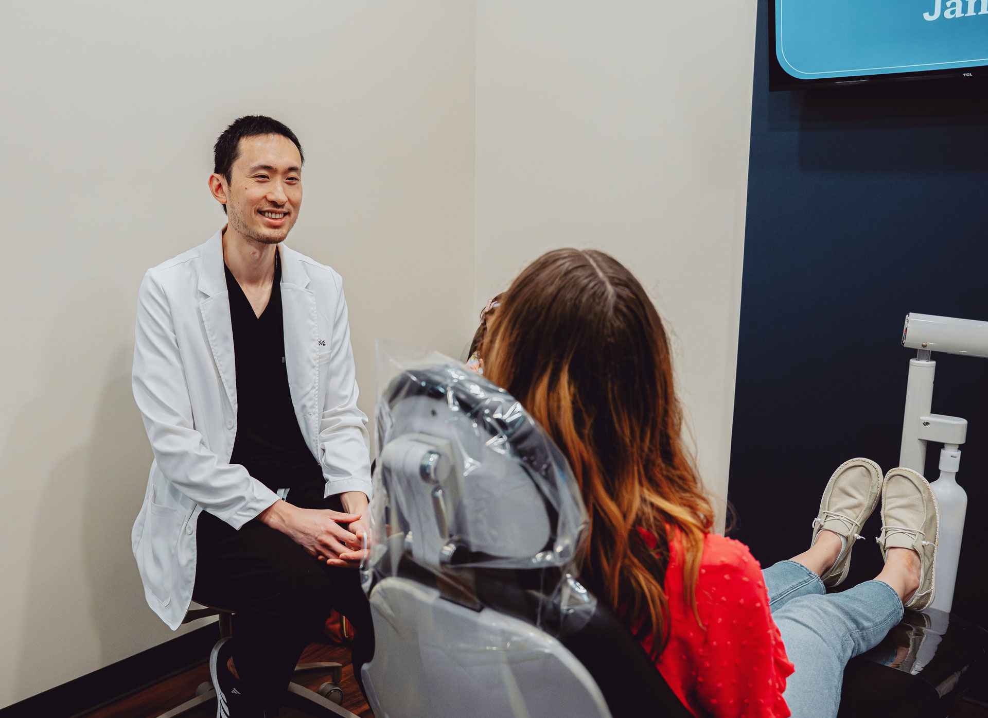 Patient smiling with dental staff at Hometown Smiles Dentistry in League City, TX