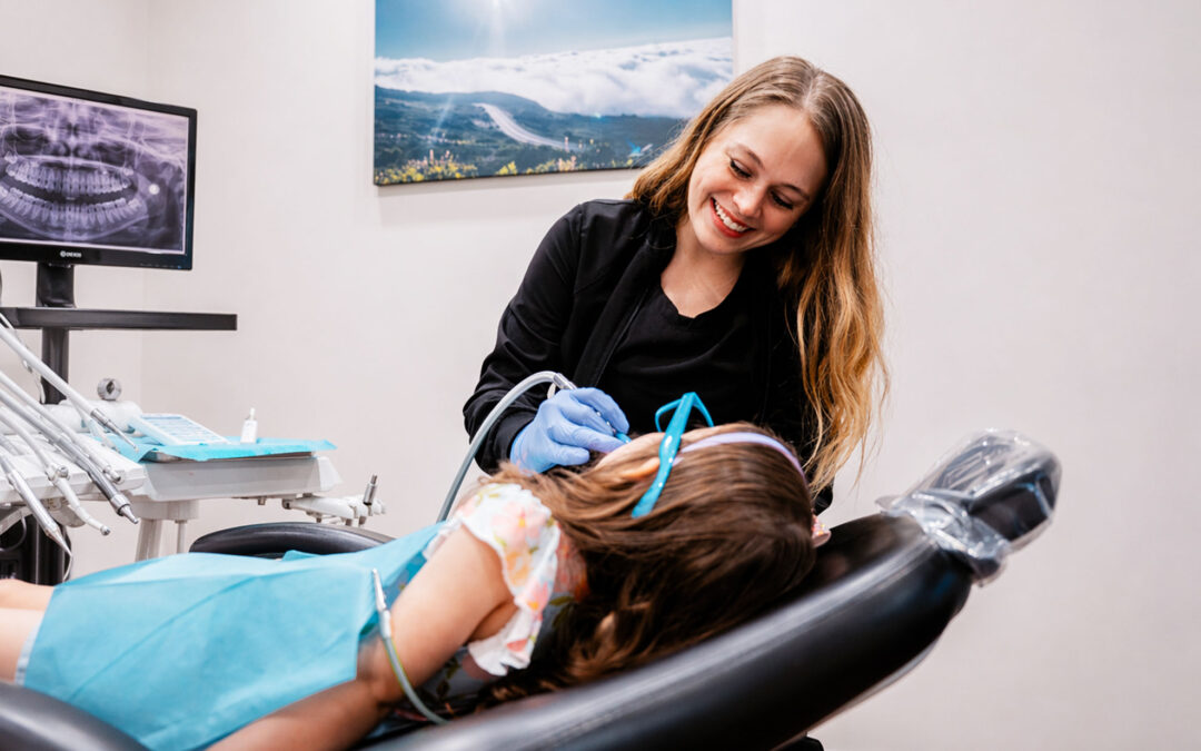 Dentist treating young patient at Hometown Smiles Dentistry in League City, TX