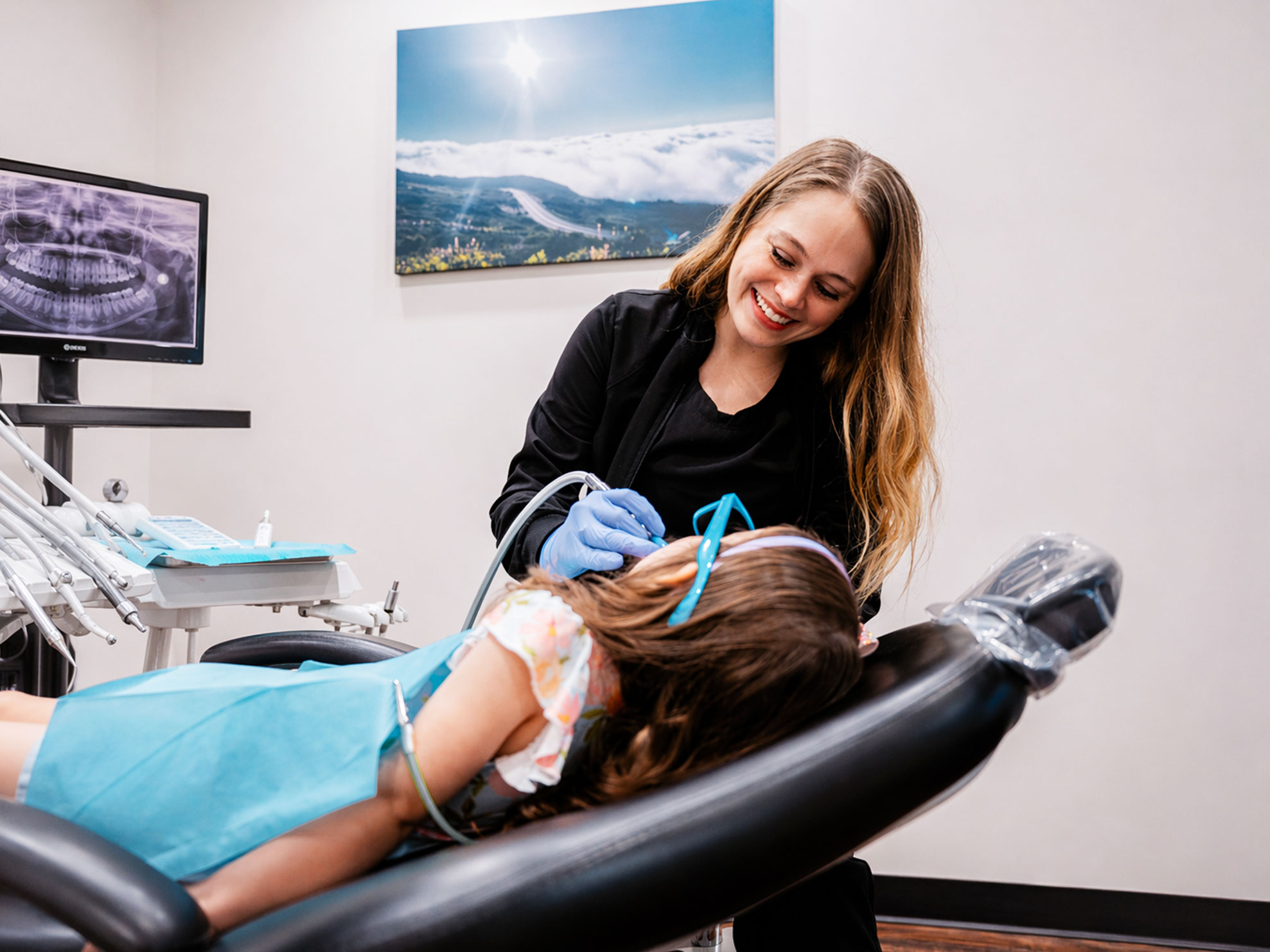 Dentist treating young patient at Hometown Smiles Dentistry in League City, TX