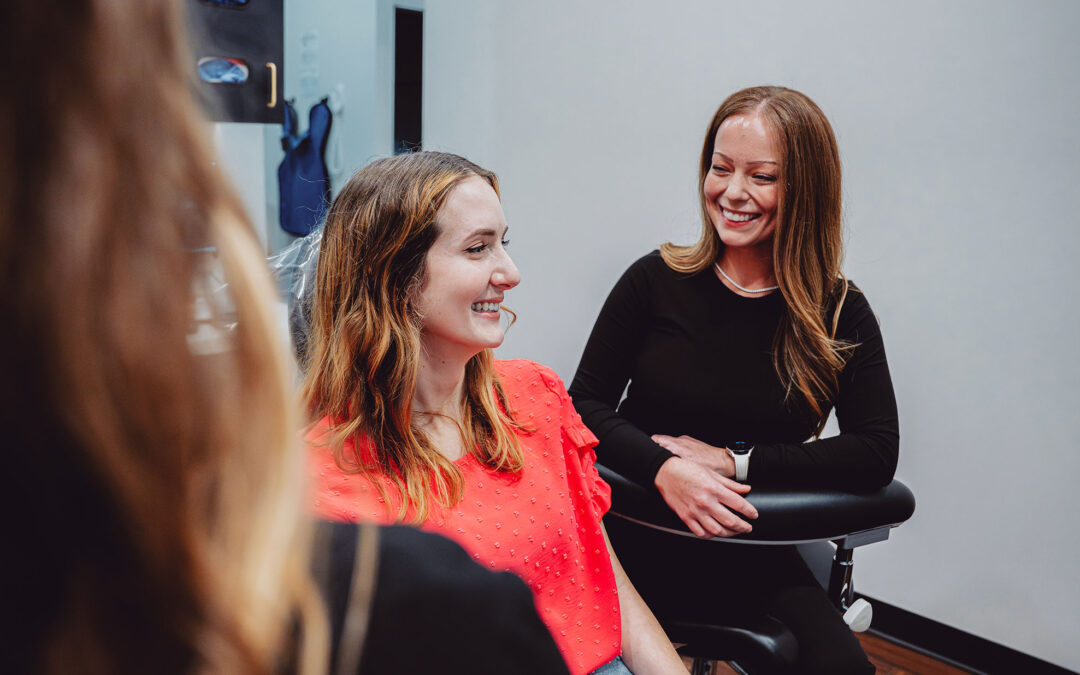 Two women smiling and talking at Hometown Smiles Dentistry in League City, TX