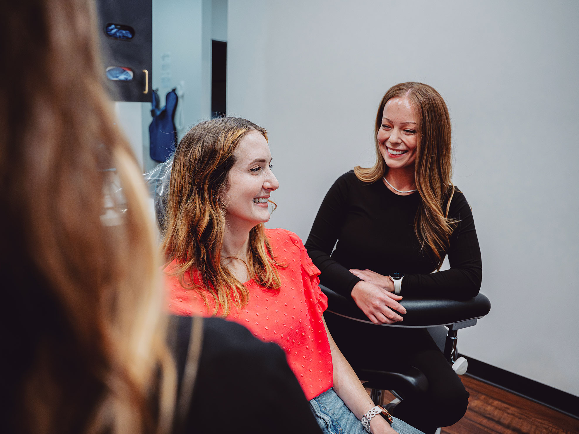 Two women smiling and talking at Hometown Smiles Dentistry in League City, TX