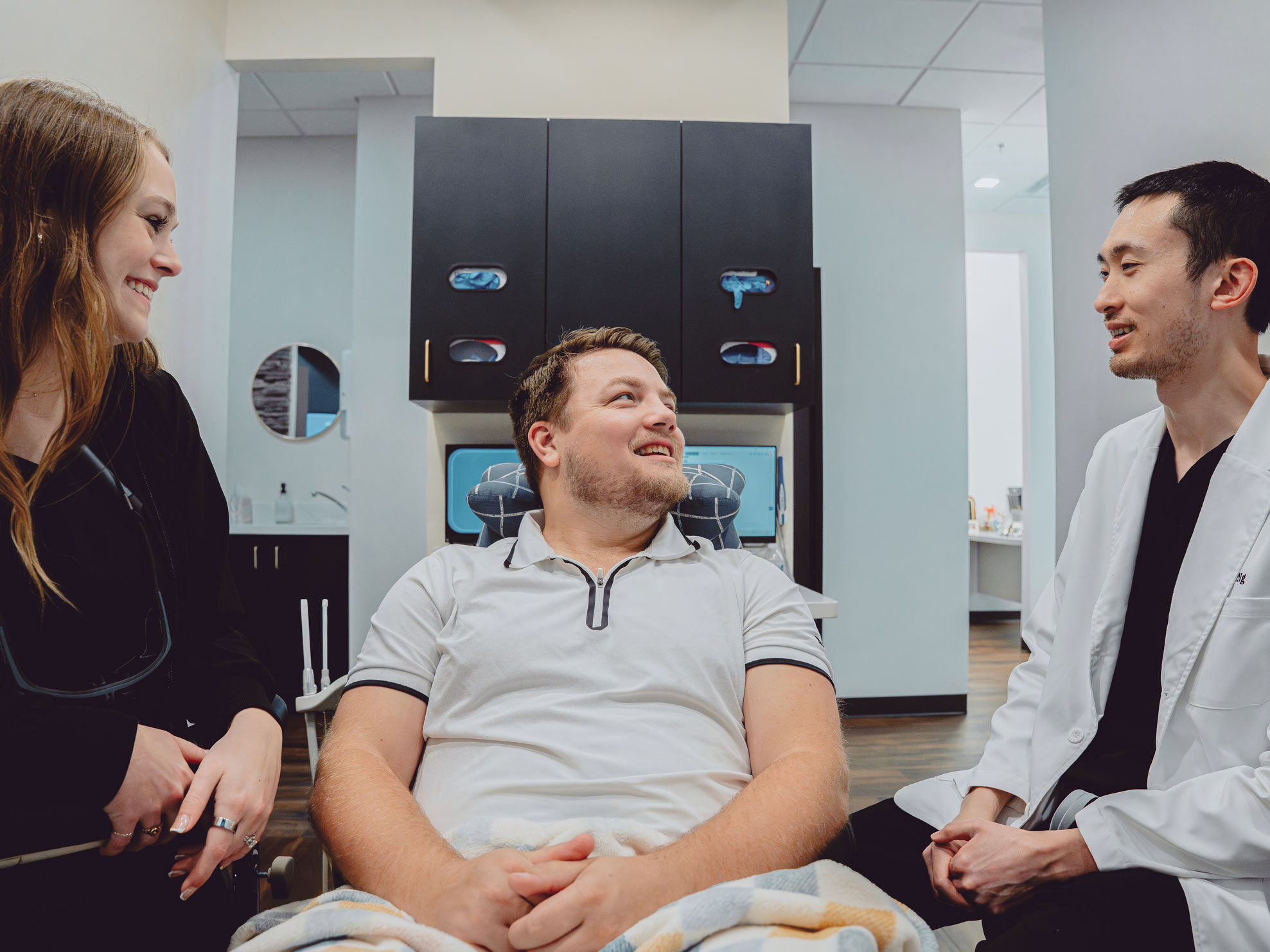 Patient smiling with dental staff at Hometown Smiles Dentistry in League City, TX