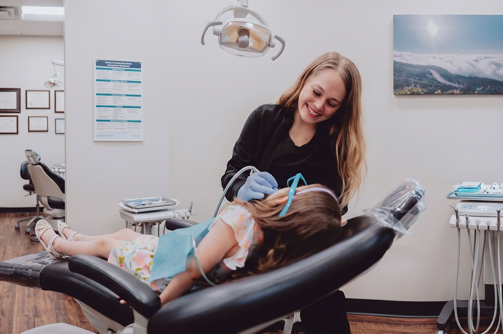 Dentist treating young patient at Hometown Smiles Dentistry in League City, TX